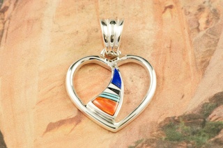 Genuine Turquoise, Spiny Oyster Shell, Magnesite and Blue Lapis inlaid in Sterling Silver. Free 18" Sterling Silver Chain with Purchase of Pendant. Beautiful Heart Pendant Designed by Navajo Artist Calvin Begay. Signed.